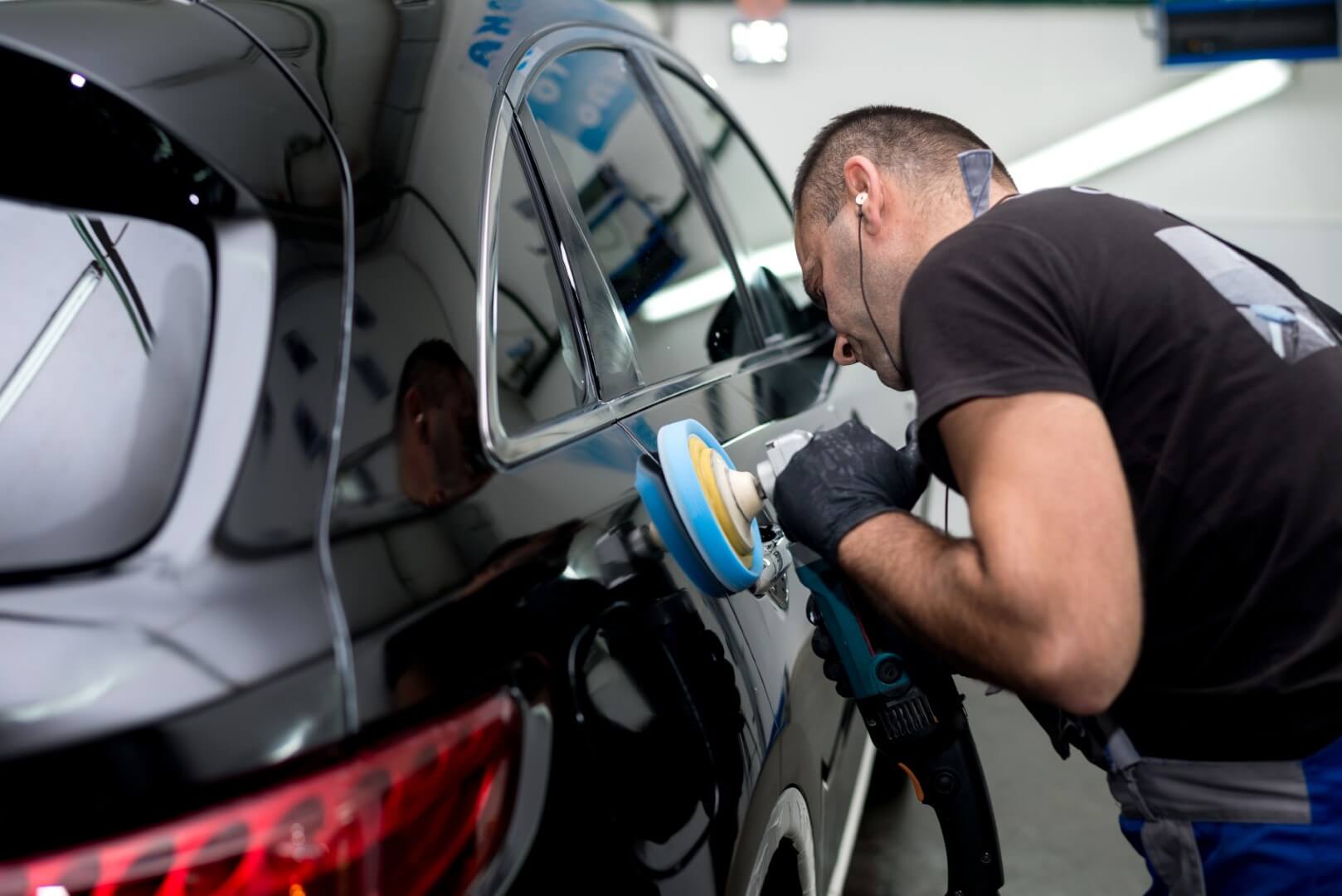 Car detailing expert from Stouffville waxing a car.